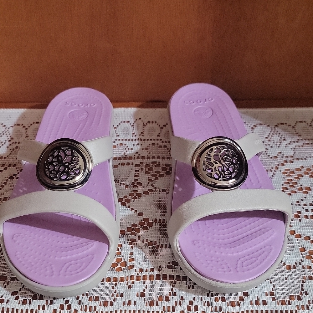 Women’s Crocs Lavender and Grey Slide Sandals with Decorative Silver Medallion